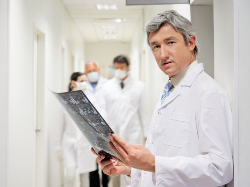 Radiologist-holding-film-hallway-cropped-1 MRI Imaging TOS