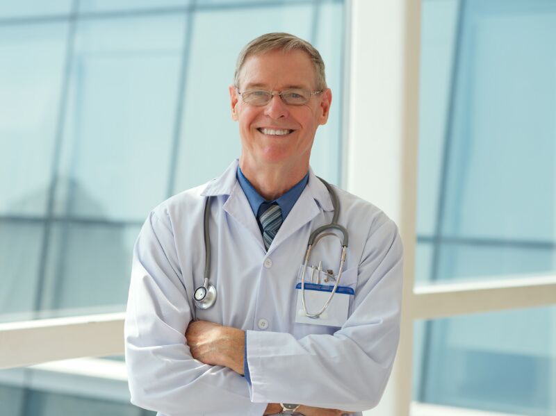 Male-Happy-Mature-Doctor-Side-Light-2 Primary care physician